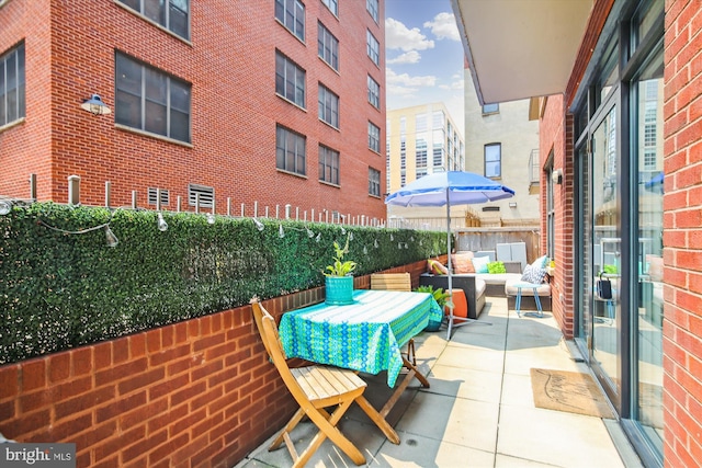 balcony with an outdoor hangout area and a patio area