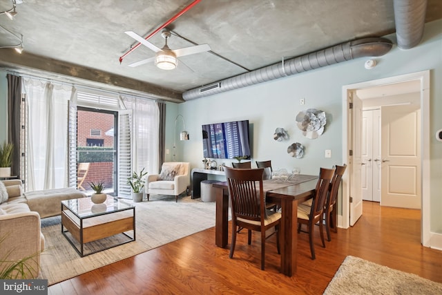 dining space with hardwood / wood-style flooring and ceiling fan