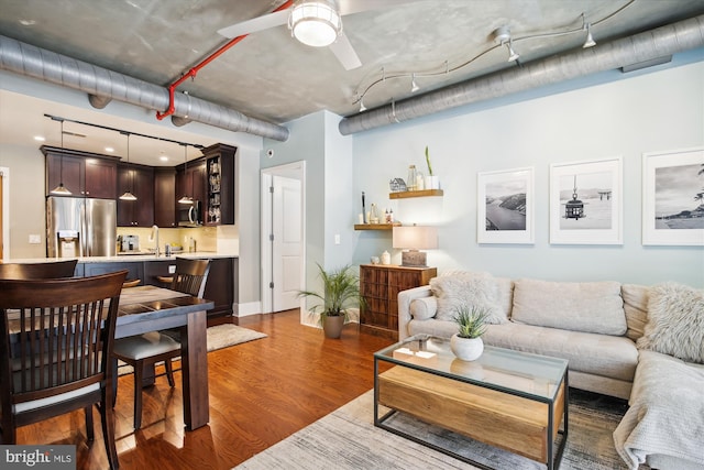 living room featuring ceiling fan, dark hardwood / wood-style flooring, and sink