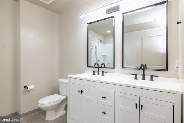 bathroom with vanity, a shower, tile patterned floors, and toilet