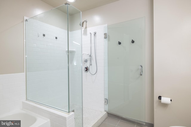 bathroom featuring separate shower and tub and tile patterned flooring