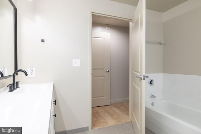 bathroom with vanity and a tub