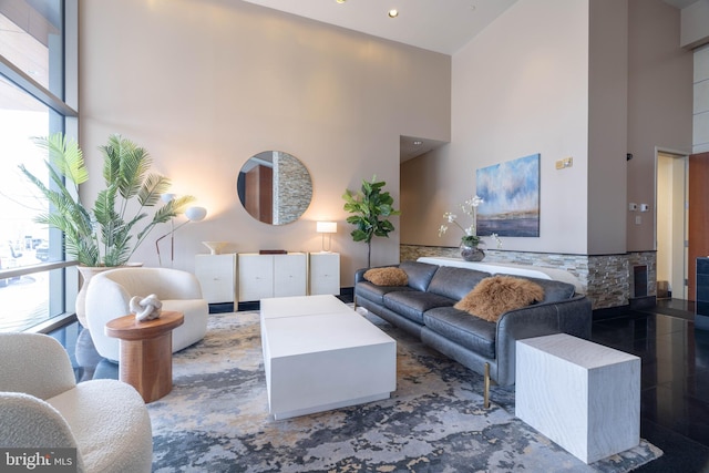 living room with a towering ceiling and a wealth of natural light