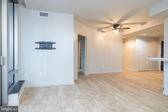 unfurnished living room with light hardwood / wood-style flooring and ceiling fan