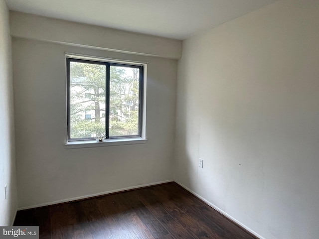 empty room with dark hardwood / wood-style floors