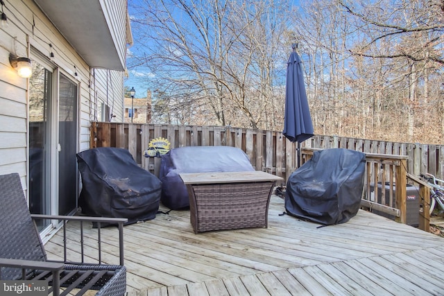 wooden deck featuring a grill