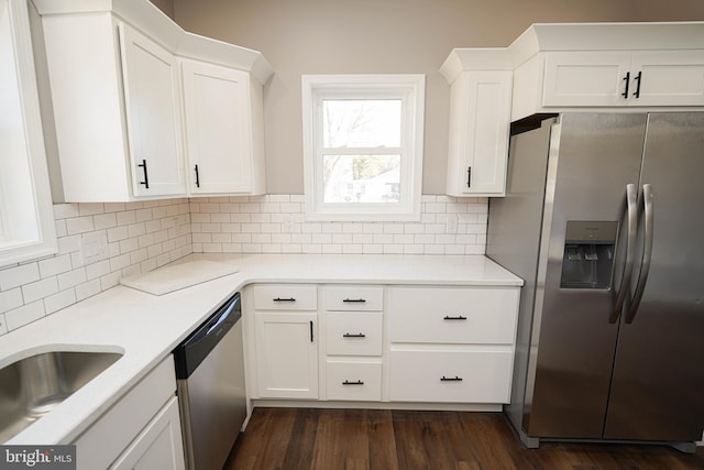 kitchen featuring tasteful backsplash, dark wood-type flooring, stainless steel appliances, and white cabinets