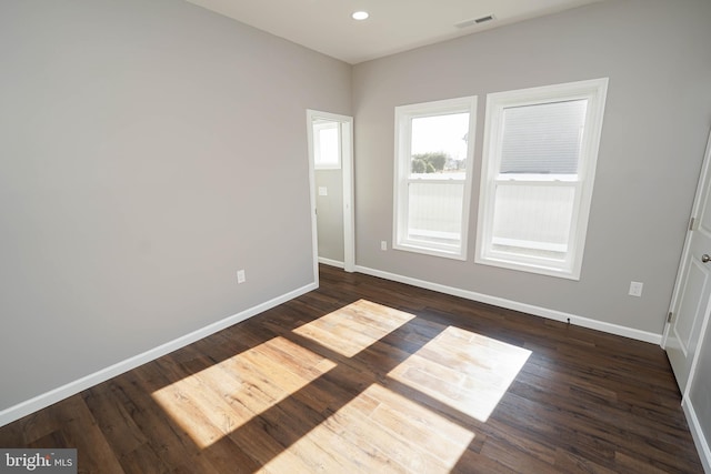 spare room featuring dark hardwood / wood-style floors