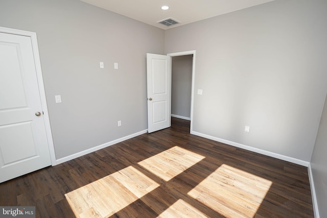 unfurnished bedroom featuring dark wood-type flooring