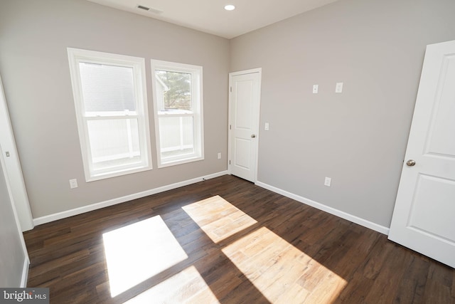 unfurnished bedroom with dark wood-type flooring