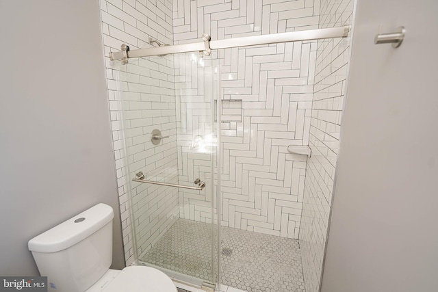 bathroom with toilet and walk in shower