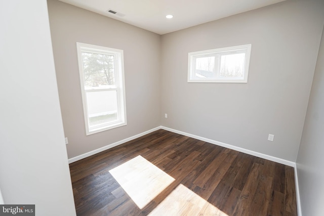 unfurnished room featuring dark wood-type flooring