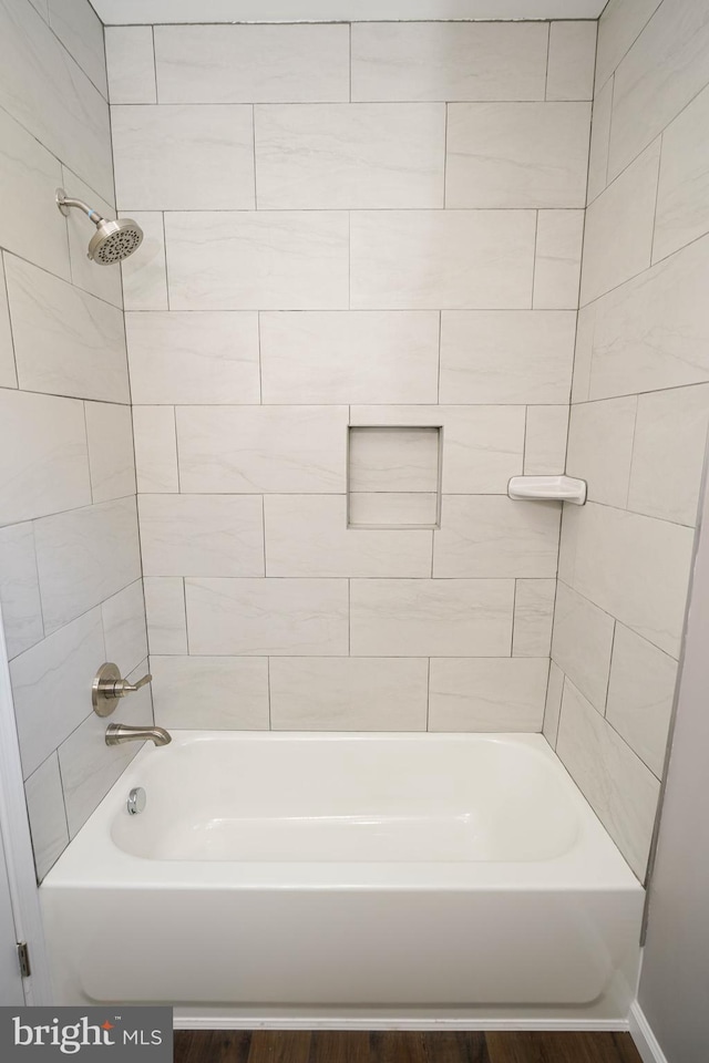 bathroom featuring hardwood / wood-style floors and tiled shower / bath combo