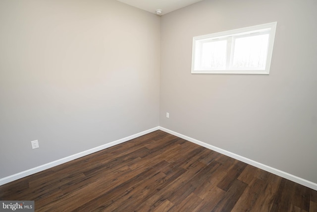 spare room with dark wood-type flooring