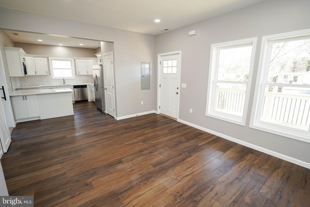 foyer entrance with dark hardwood / wood-style flooring and electric panel