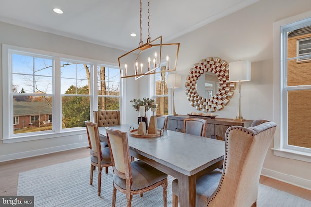 dining room featuring crown molding, light hardwood / wood-style floors, and a notable chandelier