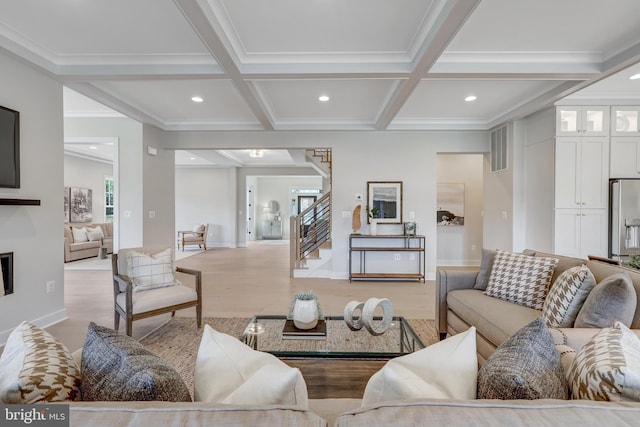 living room featuring coffered ceiling, beam ceiling, light hardwood / wood-style floors, and crown molding