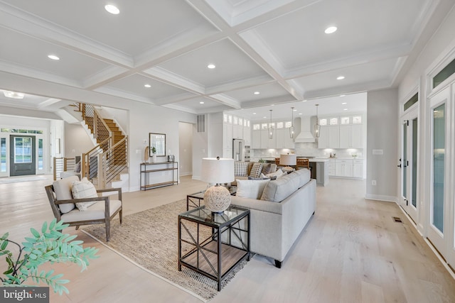 living room featuring beamed ceiling, coffered ceiling, and light hardwood / wood-style flooring