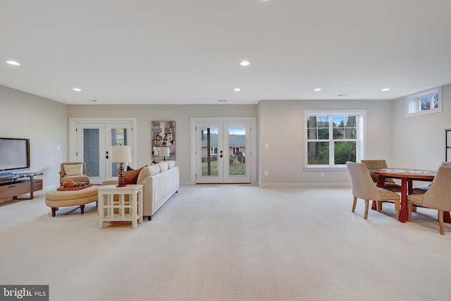 carpeted living room featuring french doors