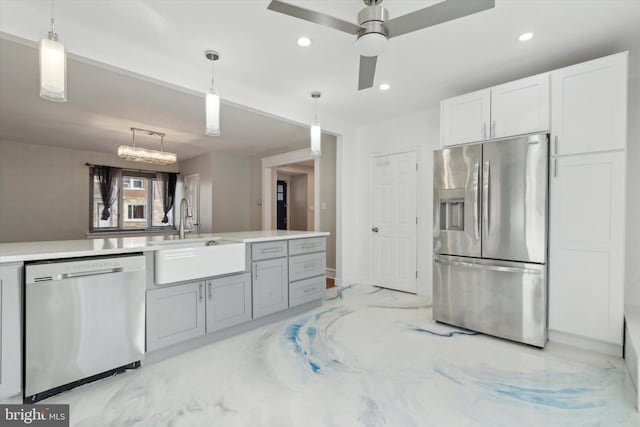 kitchen with sink, gray cabinetry, decorative light fixtures, appliances with stainless steel finishes, and white cabinets