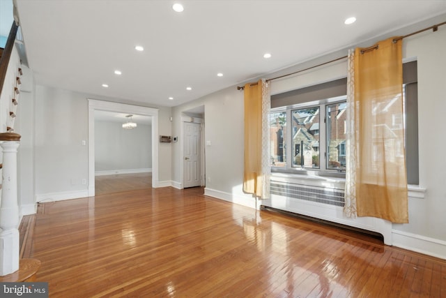 unfurnished living room with hardwood / wood-style flooring