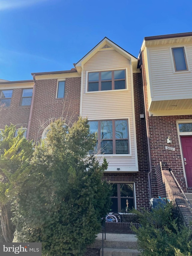 view of property featuring brick siding