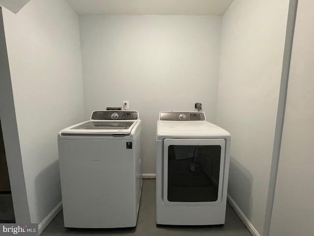 laundry room with washer and dryer, laundry area, and baseboards