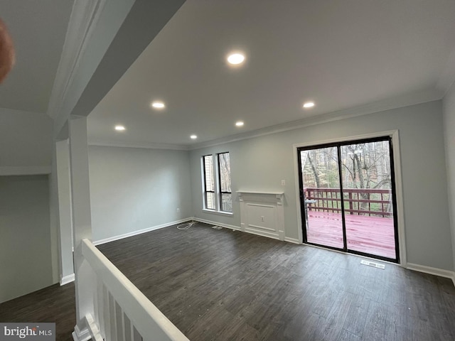 spare room featuring dark wood-style floors, ornamental molding, recessed lighting, and baseboards