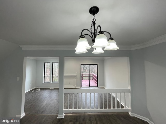 interior space with baseboards, ornamental molding, dark wood finished floors, and a notable chandelier