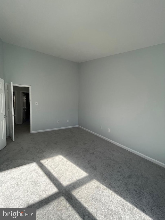 unfurnished bedroom with carpet flooring and baseboards