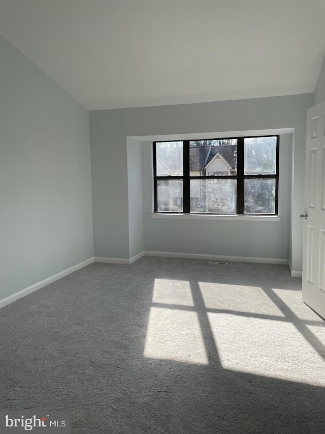 unfurnished room featuring carpet flooring and baseboards