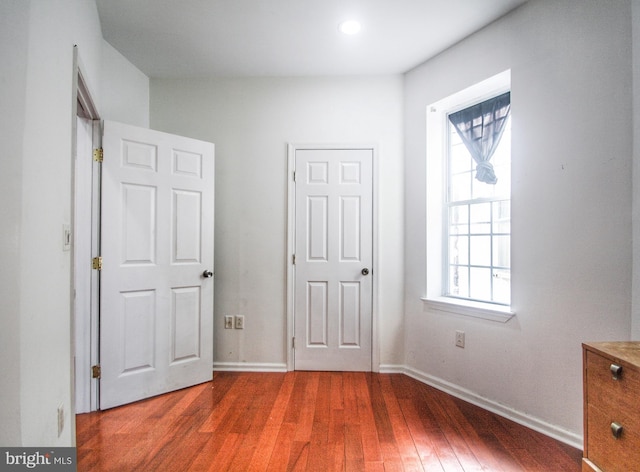 unfurnished bedroom with dark hardwood / wood-style floors