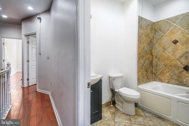 bathroom featuring vanity, toilet, and a bathing tub