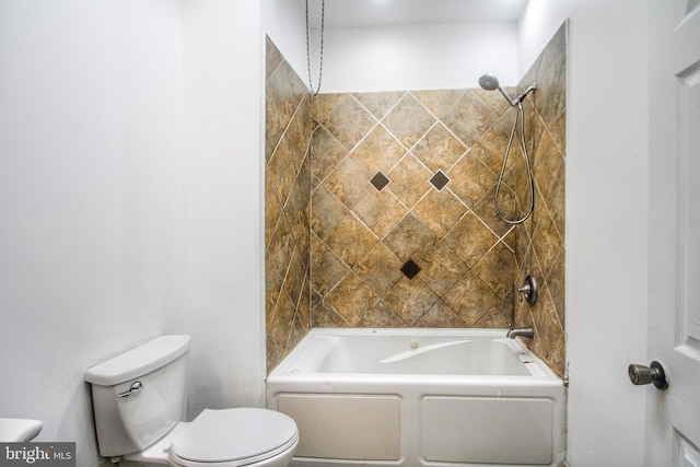 bathroom featuring toilet and tiled shower / bath combo