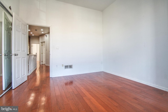 unfurnished room with dark hardwood / wood-style floors