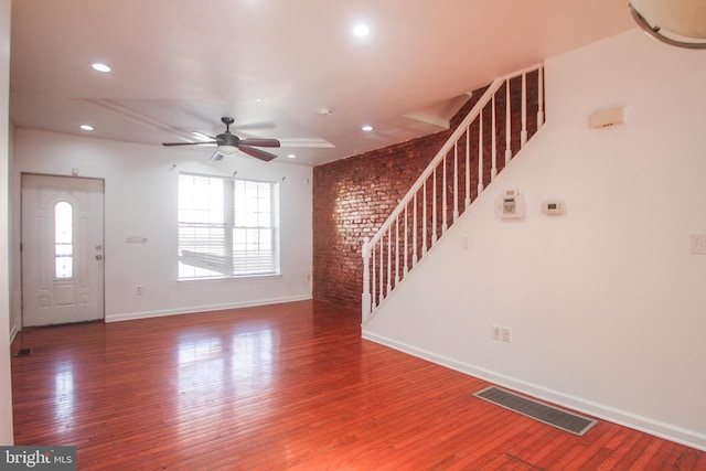 unfurnished living room with hardwood / wood-style flooring and ceiling fan