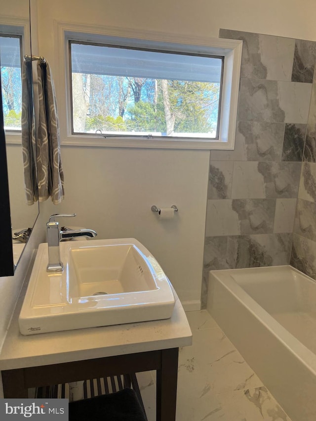 bathroom featuring sink and a bath