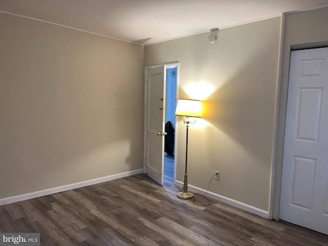 unfurnished room with dark hardwood / wood-style floors