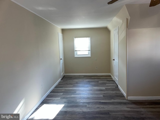 spare room with dark hardwood / wood-style floors and ceiling fan