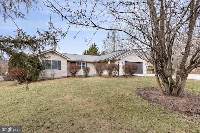 ranch-style house featuring a garage and a front lawn