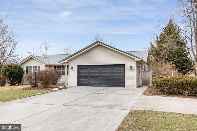 single story home featuring a garage and a front lawn