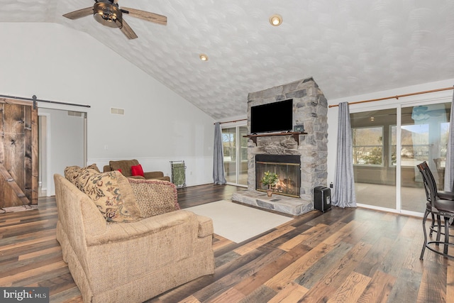 living room with hardwood / wood-style flooring, a barn door, and a healthy amount of sunlight