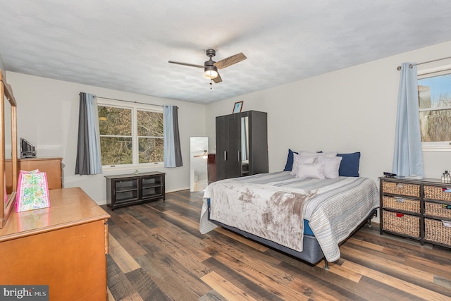 bedroom with ceiling fan and dark hardwood / wood-style flooring