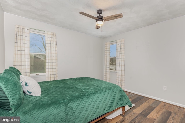 bedroom with dark wood-type flooring and ceiling fan