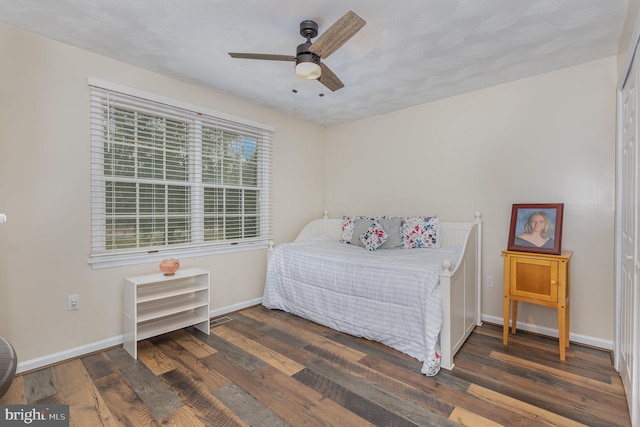 bedroom featuring dark wood-type flooring and ceiling fan