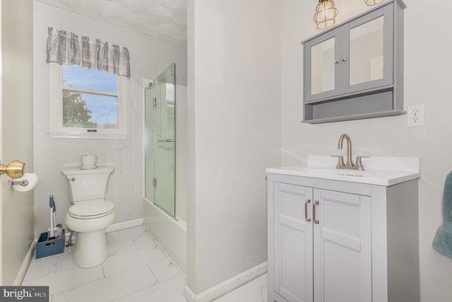 full bathroom featuring vanity, shower / bath combination with glass door, and toilet