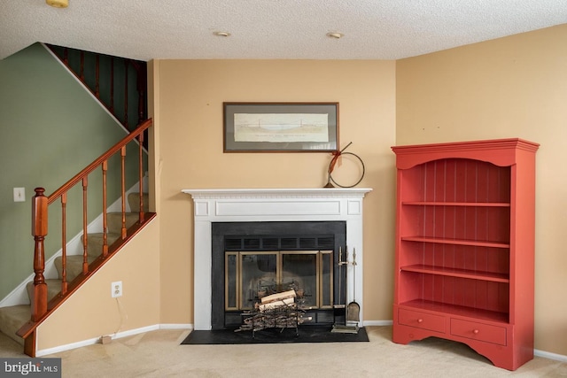 living room with a fireplace with flush hearth, light colored carpet, and stairs