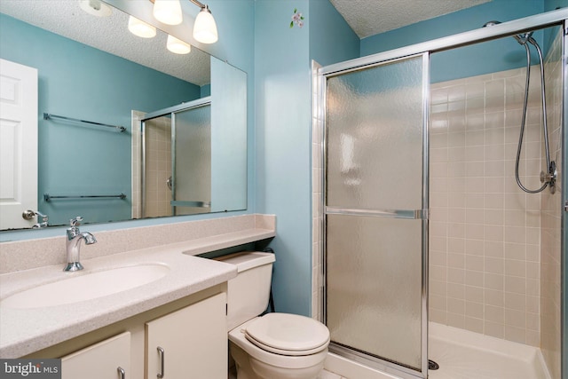 bathroom with toilet, a tile shower, a textured ceiling, and vanity