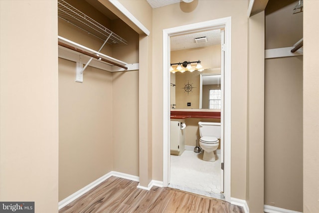 spacious closet with visible vents and wood finished floors