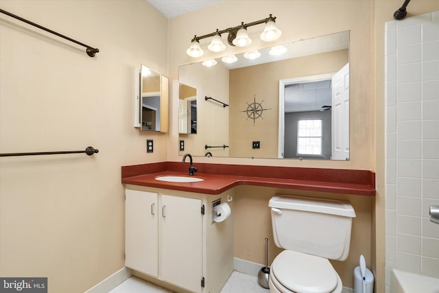 bathroom with vanity, toilet, and baseboards